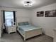 Guest bedroom with a double bed, nightstand, and window coverings at 1254 Wispy Cypress Dr, Kissimmee, FL 34746