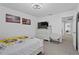 Bright bedroom featuring a queen bed, dresser, and access to hallway at 1254 Wispy Cypress Dr, Kissimmee, FL 34746