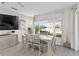 Bright dining room features a large table with six chairs, and a view to the backyard at 1254 Wispy Cypress Dr, Kissimmee, FL 34746