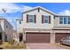 Two-story townhome with brown garage door and stone accents at 1254 Wispy Cypress Dr, Kissimmee, FL 34746