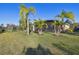 Screened patio and spacious backyard with palm trees at 135 Lemon Grove Dr, Poinciana, FL 34759