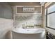Spa-like bathroom with soaking tub and mosaic tile details at 135 Lemon Grove Dr, Poinciana, FL 34759