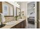 Double vanity bathroom with view into bedroom at 135 Lemon Grove Dr, Poinciana, FL 34759