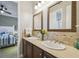 Double vanity bathroom with decorative mirrors at 135 Lemon Grove Dr, Poinciana, FL 34759