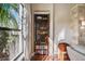 Built-in wooden bookcase with various books and collectibles at 135 Lemon Grove Dr, Poinciana, FL 34759