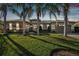 Tan house with palm trees and a two-car garage at 135 Lemon Grove Dr, Poinciana, FL 34759