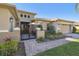 Landscaped front yard with pavers, gate, and palm trees at 135 Lemon Grove Dr, Poinciana, FL 34759
