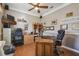 Home office with wood desk, ample storage, and hardwood floors at 135 Lemon Grove Dr, Poinciana, FL 34759