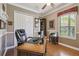 Home office features built-in shelving, large desk, and window with blinds at 135 Lemon Grove Dr, Poinciana, FL 34759