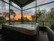 Hot tub on a screened porch overlooking a sunset at 135 Lemon Grove Dr, Poinciana, FL 34759