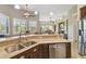 Spacious kitchen with island, stainless steel appliances, and ample counter space at 135 Lemon Grove Dr, Poinciana, FL 34759