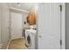 Convenient laundry room with washer, dryer, and storage cabinets at 135 Lemon Grove Dr, Poinciana, FL 34759