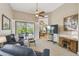 Spacious living area featuring a large TV and view into dining area at 135 Lemon Grove Dr, Poinciana, FL 34759