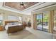 Spacious main bedroom with king-size bed and access to backyard patio at 135 Lemon Grove Dr, Poinciana, FL 34759