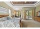 Bright main bedroom with king-size bed and access to backyard patio at 135 Lemon Grove Dr, Poinciana, FL 34759