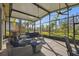 Relaxing screened-in porch with patio furniture and pool view at 135 Lemon Grove Dr, Poinciana, FL 34759