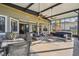 Large screened porch with comfortable seating and dining area at 135 Lemon Grove Dr, Poinciana, FL 34759