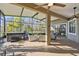 Screened porch with hot tub and view of backyard at 135 Lemon Grove Dr, Poinciana, FL 34759