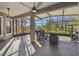 Spacious screened-in porch with comfortable seating and a view of the backyard at 135 Lemon Grove Dr, Poinciana, FL 34759