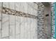 Shower with marble and stone tile detail at 135 Lemon Grove Dr, Poinciana, FL 34759