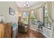 Relaxing sitting area with large windows, comfortable chair, and hardwood floors at 135 Lemon Grove Dr, Poinciana, FL 34759