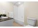 Clean bathroom with granite countertop, bathtub, and toilet at 2015 Grand Oak Dr, Kissimmee, FL 34744