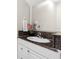 Clean bathroom with granite countertop, single sink, and a large mirror at 2015 Grand Oak Dr, Kissimmee, FL 34744
