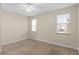 Bright bedroom with neutral walls, carpeted floors, and two windows at 2015 Grand Oak Dr, Kissimmee, FL 34744