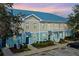 Front view of charming townhouses with blue roofs and light-colored siding at 2015 Grand Oak Dr, Kissimmee, FL 34744