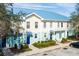 Aerial view of townhouses with blue roofs, light-colored siding, and landscaped grounds at 2015 Grand Oak Dr, Kissimmee, FL 34744
