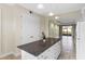 Kitchen with island, white cabinets, and view into living room at 2015 Grand Oak Dr, Kissimmee, FL 34744