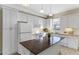 Bright kitchen featuring white cabinets, granite countertops, and an island at 2015 Grand Oak Dr, Kissimmee, FL 34744