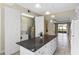 Kitchen with an island, laundry closet, and open living area view at 2015 Grand Oak Dr, Kissimmee, FL 34744