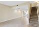 Living room with tile floors and carpeted staircase at 2015 Grand Oak Dr, Kissimmee, FL 34744