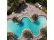 An aerial view of a stunning resort-style pool featuring multiple sections, a hot tub, and many lounge chairs at 2937 Bella Flore Ter, New Smyrna Beach, FL 32168