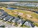 Aerial view of homes, golf course, and lake at 2937 Bella Flore Ter, New Smyrna Beach, FL 32168