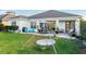 Large backyard with patio, grass, and hanging swing chair at 2937 Bella Flore Ter, New Smyrna Beach, FL 32168