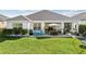 Spacious backyard with patio, grass, and landscaping at 2937 Bella Flore Ter, New Smyrna Beach, FL 32168