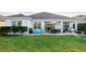 Landscaped backyard with patio and seating area at 2937 Bella Flore Ter, New Smyrna Beach, FL 32168