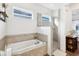 Spa-like bathroom with soaking tub, walk-in shower, and tile flooring at 2937 Bella Flore Ter, New Smyrna Beach, FL 32168