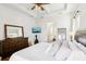 Spacious bedroom with large bed, dresser, and attached bathroom at 2937 Bella Flore Ter, New Smyrna Beach, FL 32168