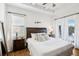 Main bedroom with plush bed, wood nightstands, and access to backyard at 2937 Bella Flore Ter, New Smyrna Beach, FL 32168