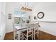 Bright dining room with farmhouse table and white chairs at 2937 Bella Flore Ter, New Smyrna Beach, FL 32168