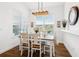 Bright dining room features a rustic farmhouse table and hardwood floors at 2937 Bella Flore Ter, New Smyrna Beach, FL 32168