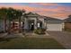 Single story home with white exterior, landscaping, and paver driveway at 2937 Bella Flore Ter, New Smyrna Beach, FL 32168