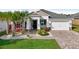 Single-story home with white exterior, landscaping, and paver driveway at 2937 Bella Flore Ter, New Smyrna Beach, FL 32168