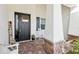 Front porch with a rocking chair and brick flooring at 2937 Bella Flore Ter, New Smyrna Beach, FL 32168