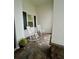 Two white rocking chairs on a brick porch at 2937 Bella Flore Ter, New Smyrna Beach, FL 32168