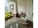 Relaxing front porch with white rocking chairs and lush greenery at 2937 Bella Flore Ter, New Smyrna Beach, FL 32168