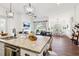Open concept kitchen with large island, granite counters, and views into Gathering room at 2937 Bella Flore Ter, New Smyrna Beach, FL 32168